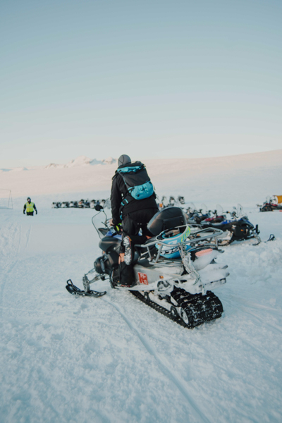 Man standing on snowmobile in Iceland