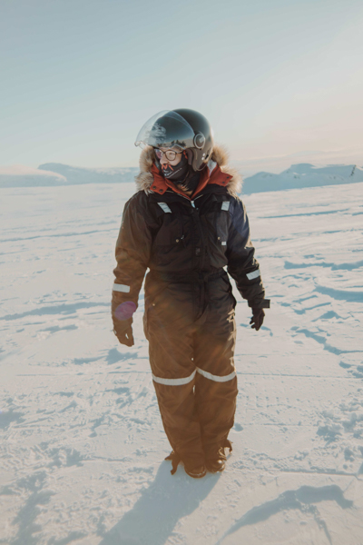 Girl in winter suit walking on glacier in Iceland