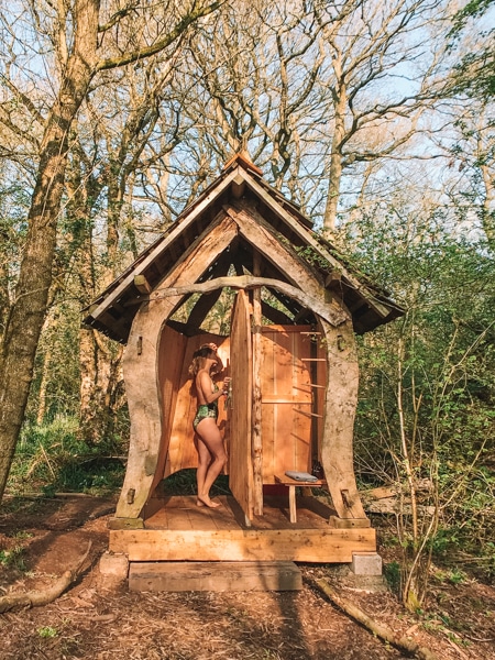 Outdoor shower block in the woods at Brook House Woods glamping