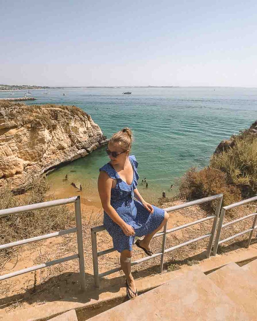 Girl sitting in front of Portugal Algarve beach