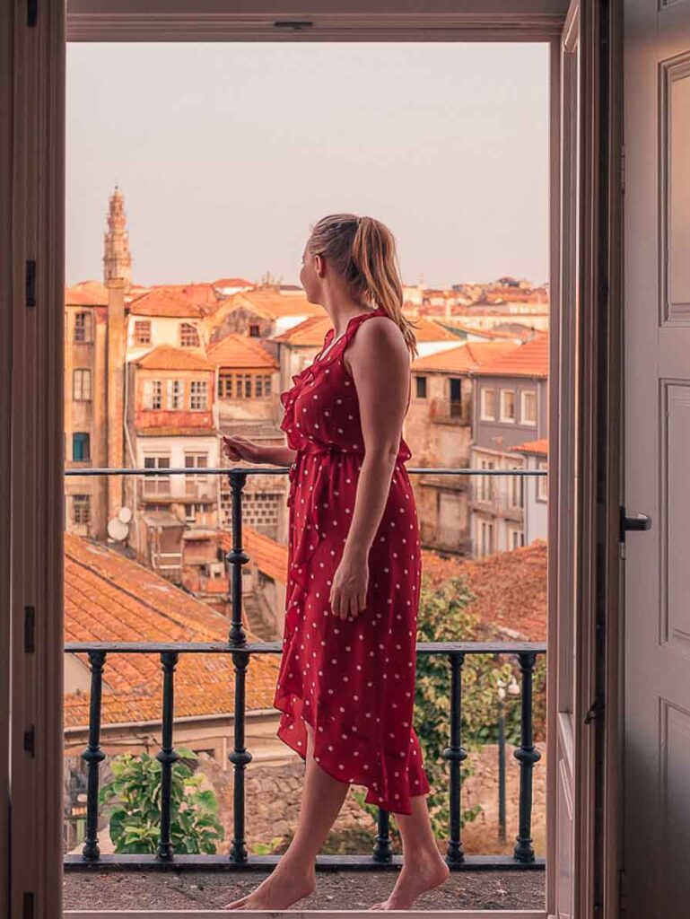 Girl standing on balcony in Porto