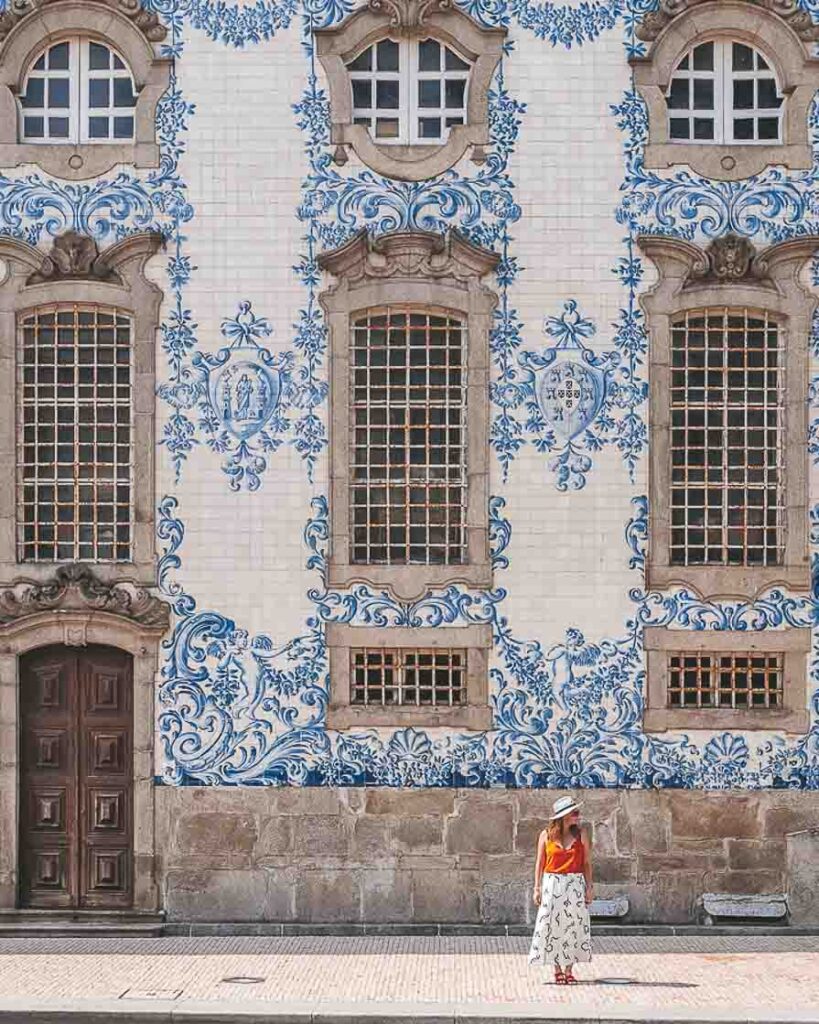 Girl standing in front of tiled church in Porto