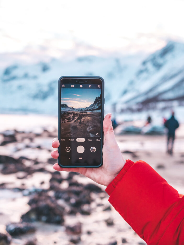 Phone taking a photo in Tromso Arctic Fjords