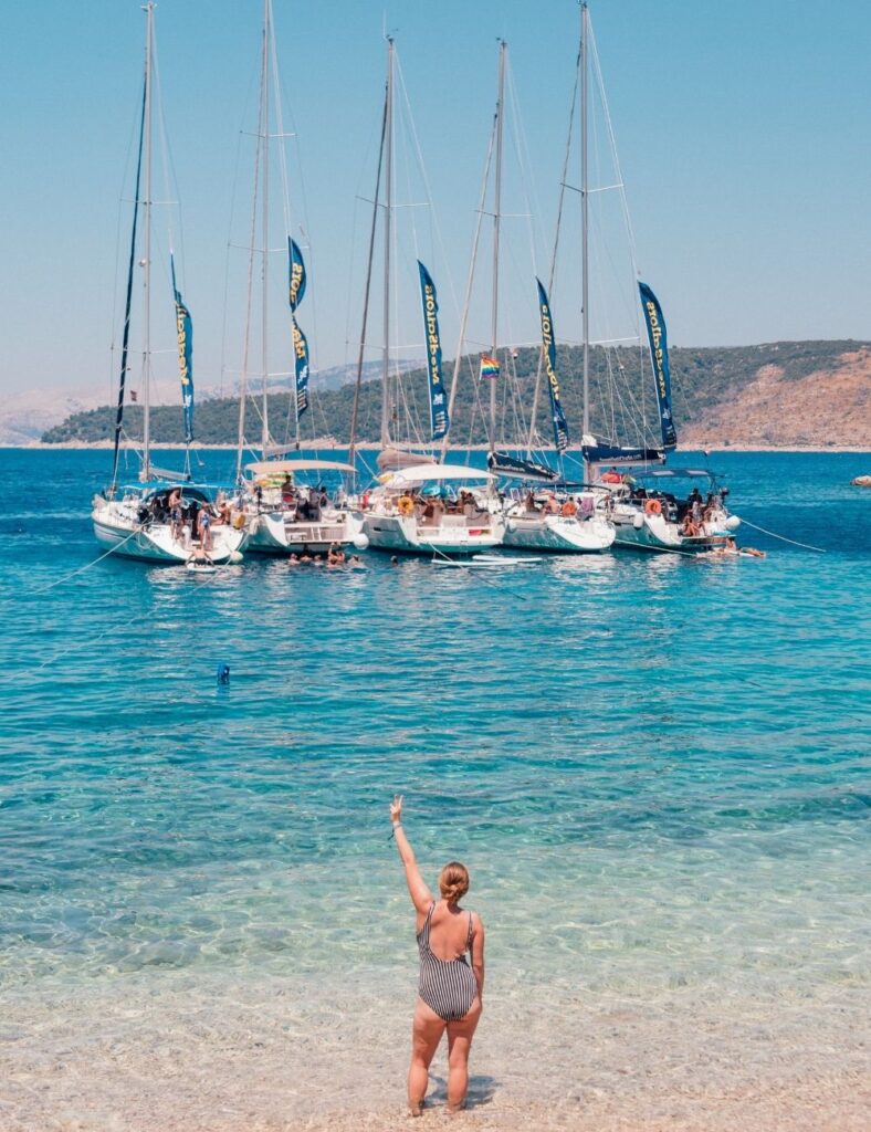 girl standing in front of yachts at the beach in croatia