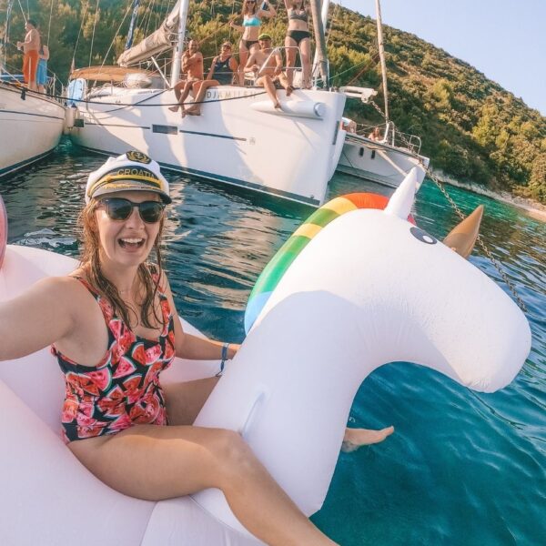 girl taking a selfie on a floating unicorn in croatia