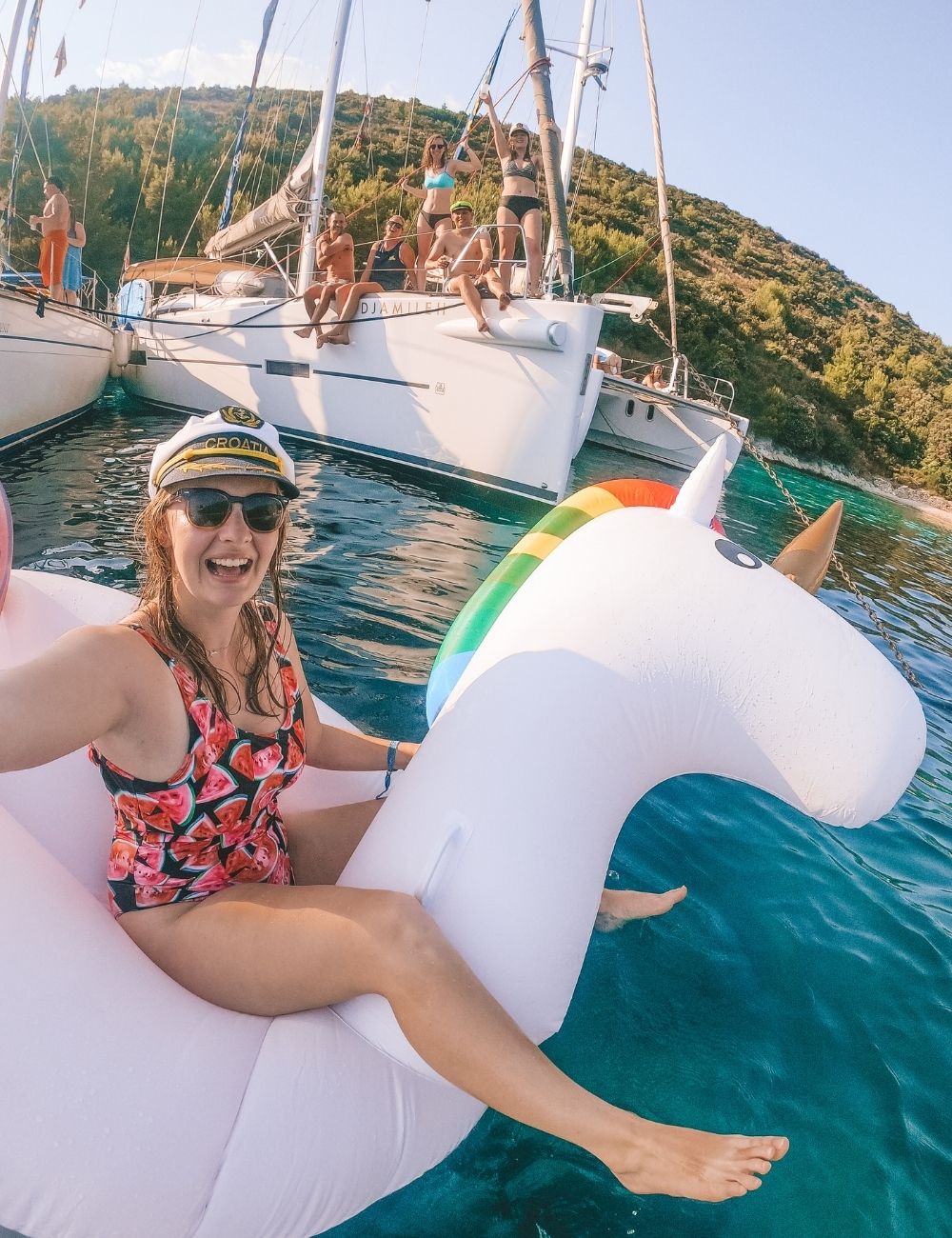 girl taking a selfie on a floating unicorn in croatia