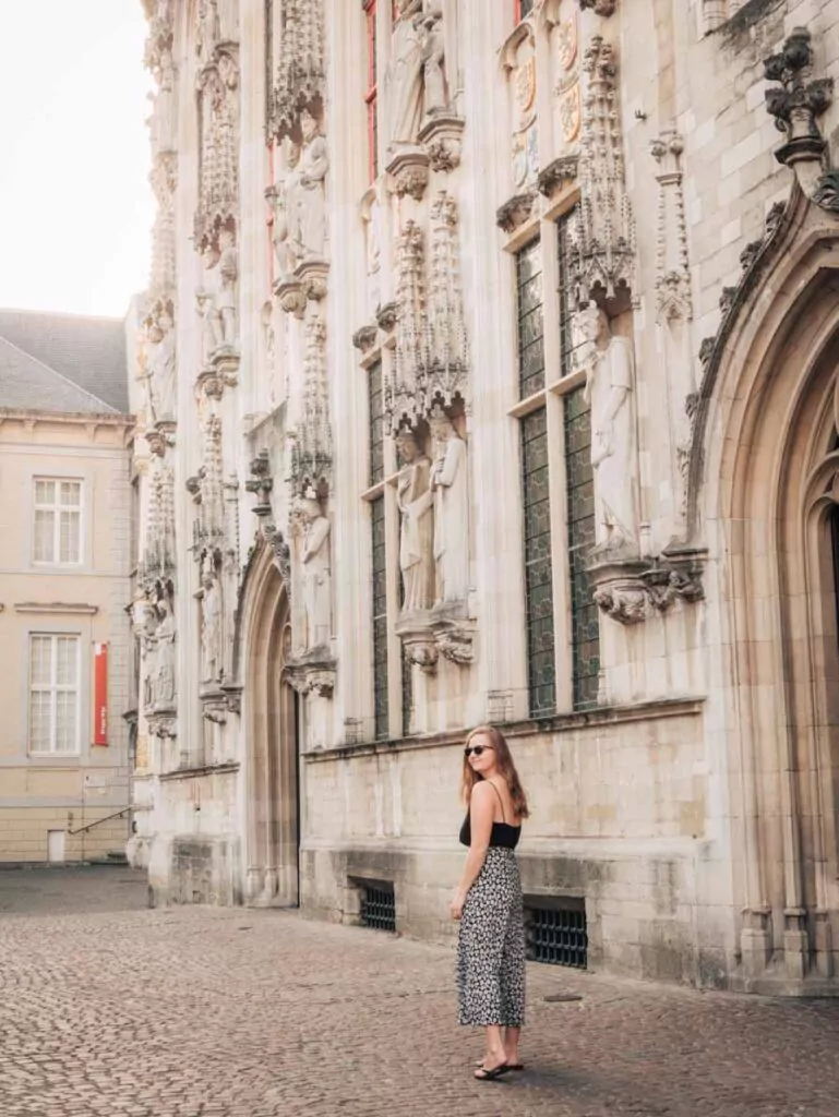 Bruges gothic architecture with girl walking in front