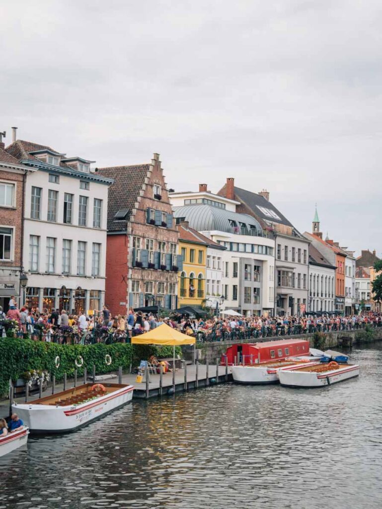 Ghent buildings and people at restaurants next to the canal