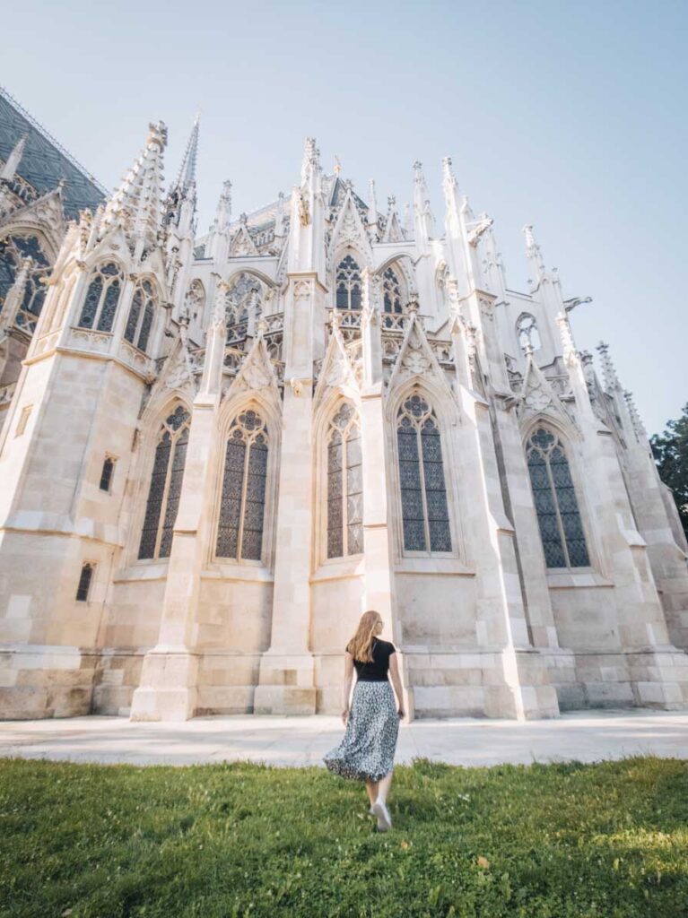 Girl standing in front of Votivekirche, Vienna