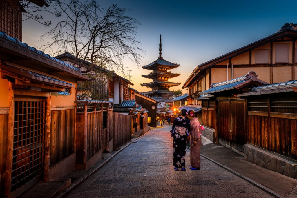 Geishas walking down road in Kyoto