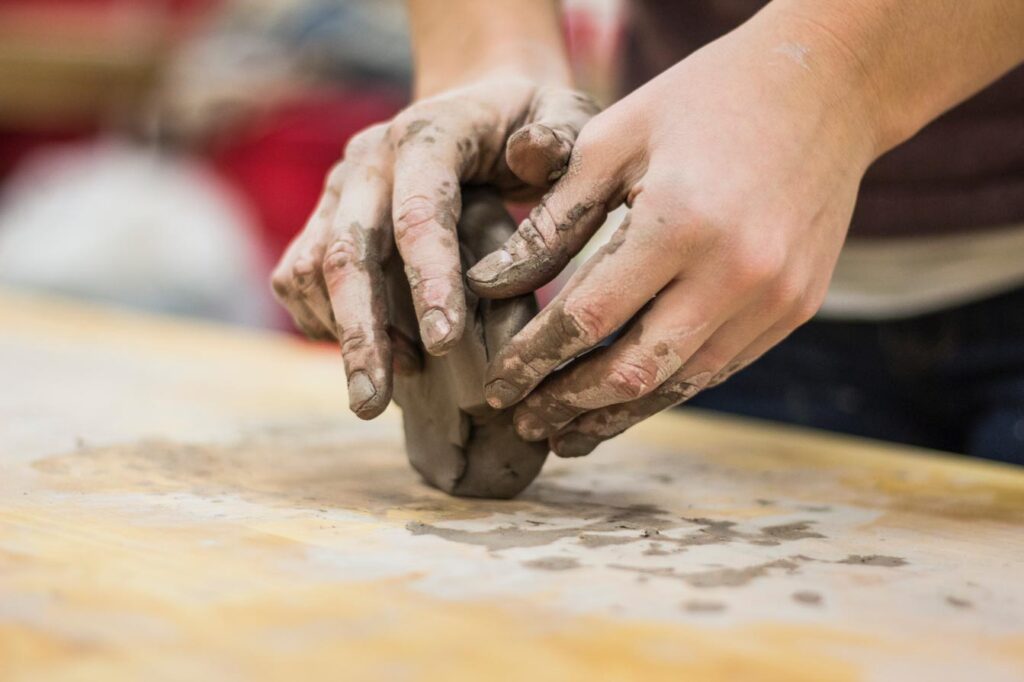 Adult hands playing with clay