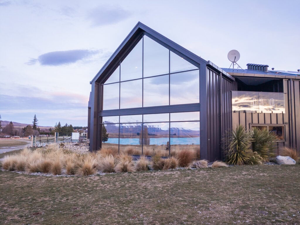 Exterior of Haka House Lake Tekapo with modern black gabled architecture and floor to ceiling windows