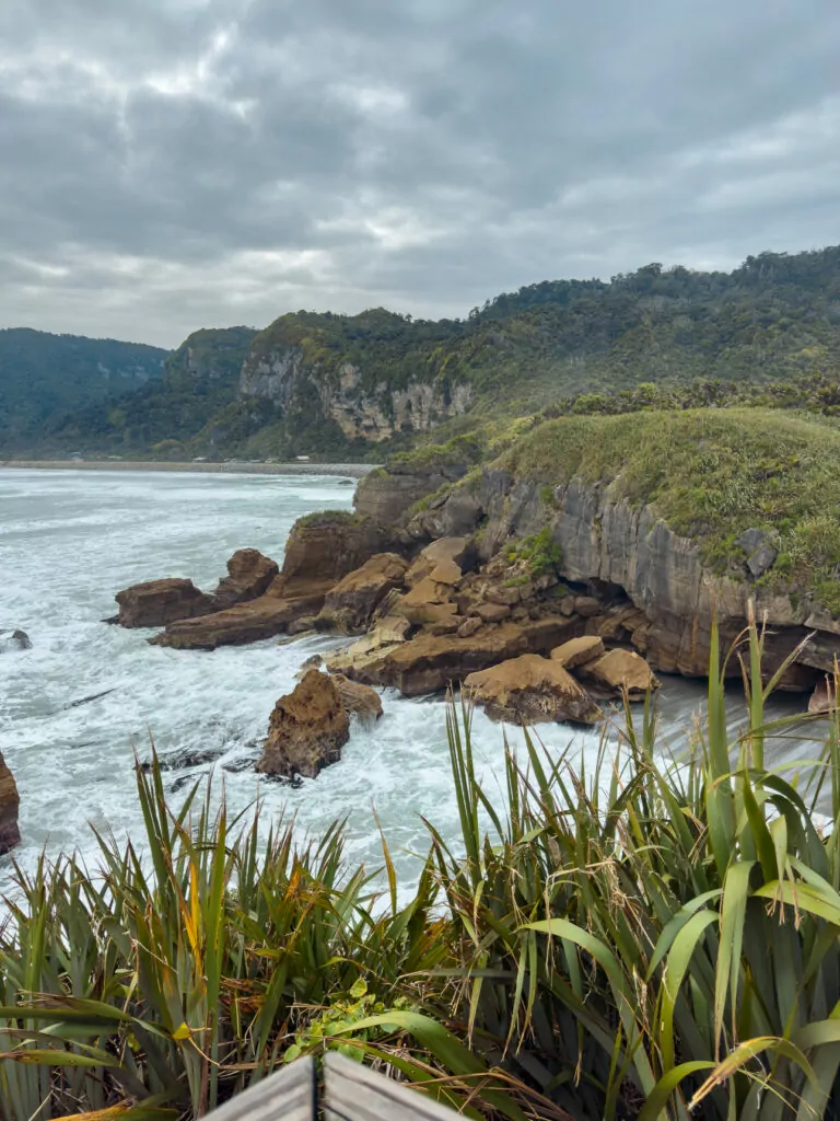 Rugged coastal cliffs and crashing waves surround the lush green headlands at Punakaiki on the West Coast of the South Island