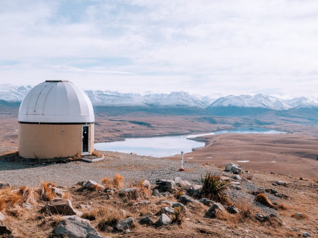 A small observatory on the summit of Mount John with Lake Alexandrina spread out in the valley below