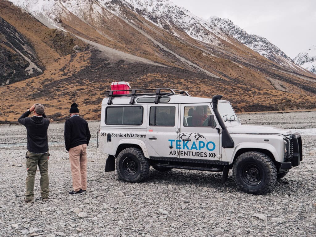 Snow-dusted mountain seen through the windscreen of a 4WD on a Tekapo Adventures backcountry tour