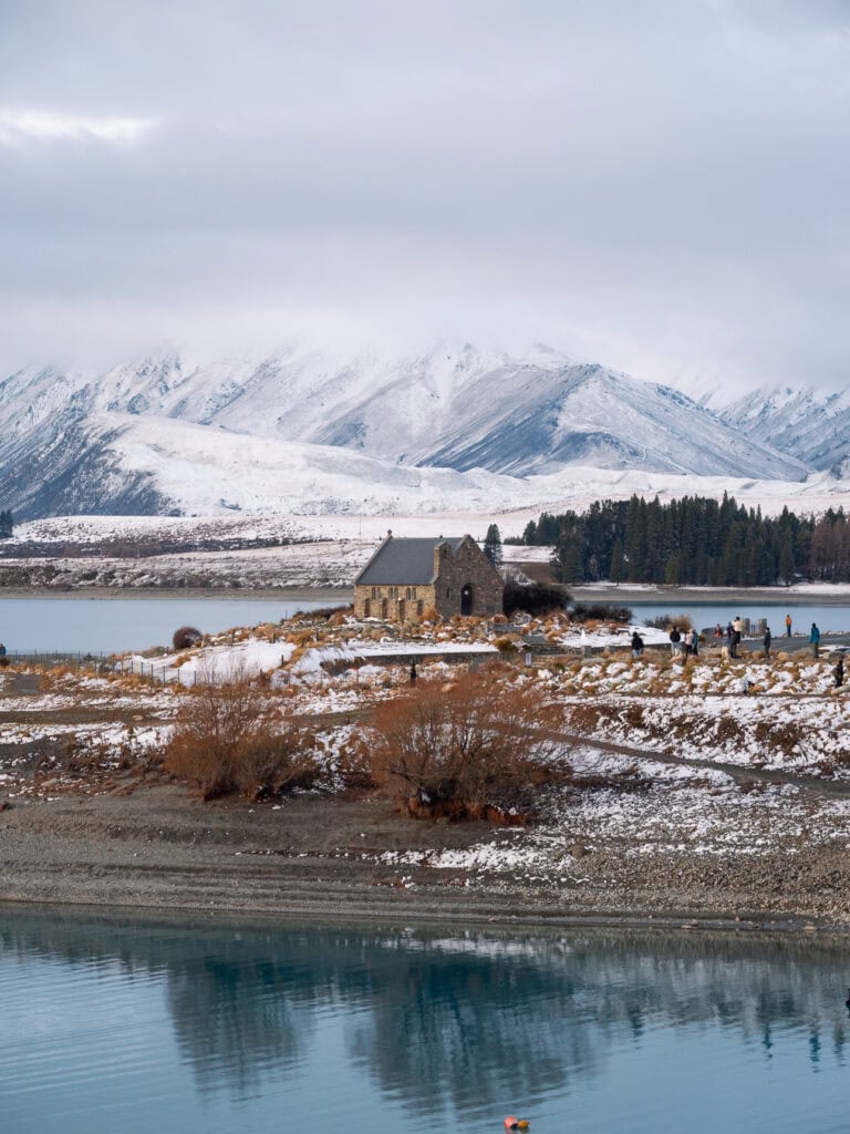 The Church of the Good Shepherd with snow-capped mountains rising behind across Lake Tekapo