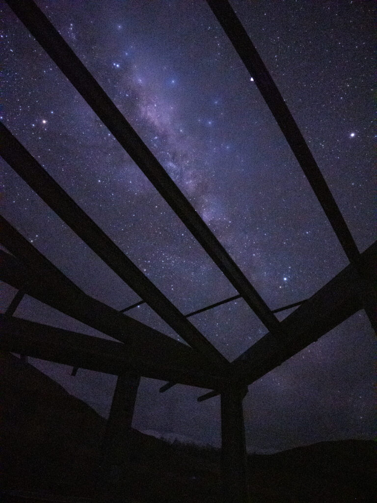 View of the Milky Way through the glass roof of SkyScape cabin in Twizel