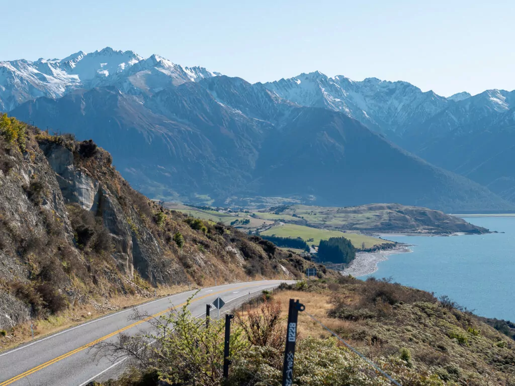 Sweeping view over Lake Hāwea and surrounding mountains with long shadows cast in the afternoon light