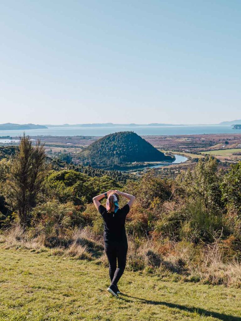 girl standing on hill in front of taupo