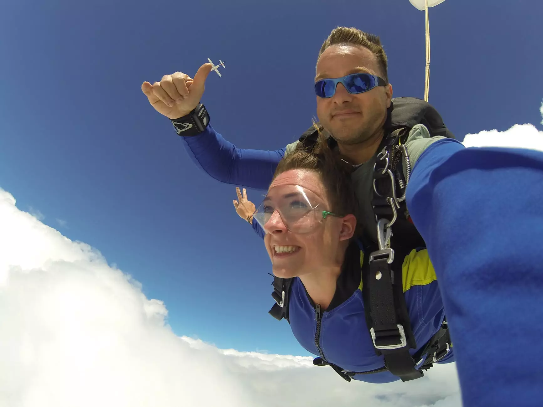 man and woman in blue jacket doing sky diving