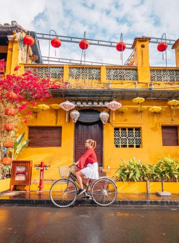 girl riding bike in hoi an vietnam