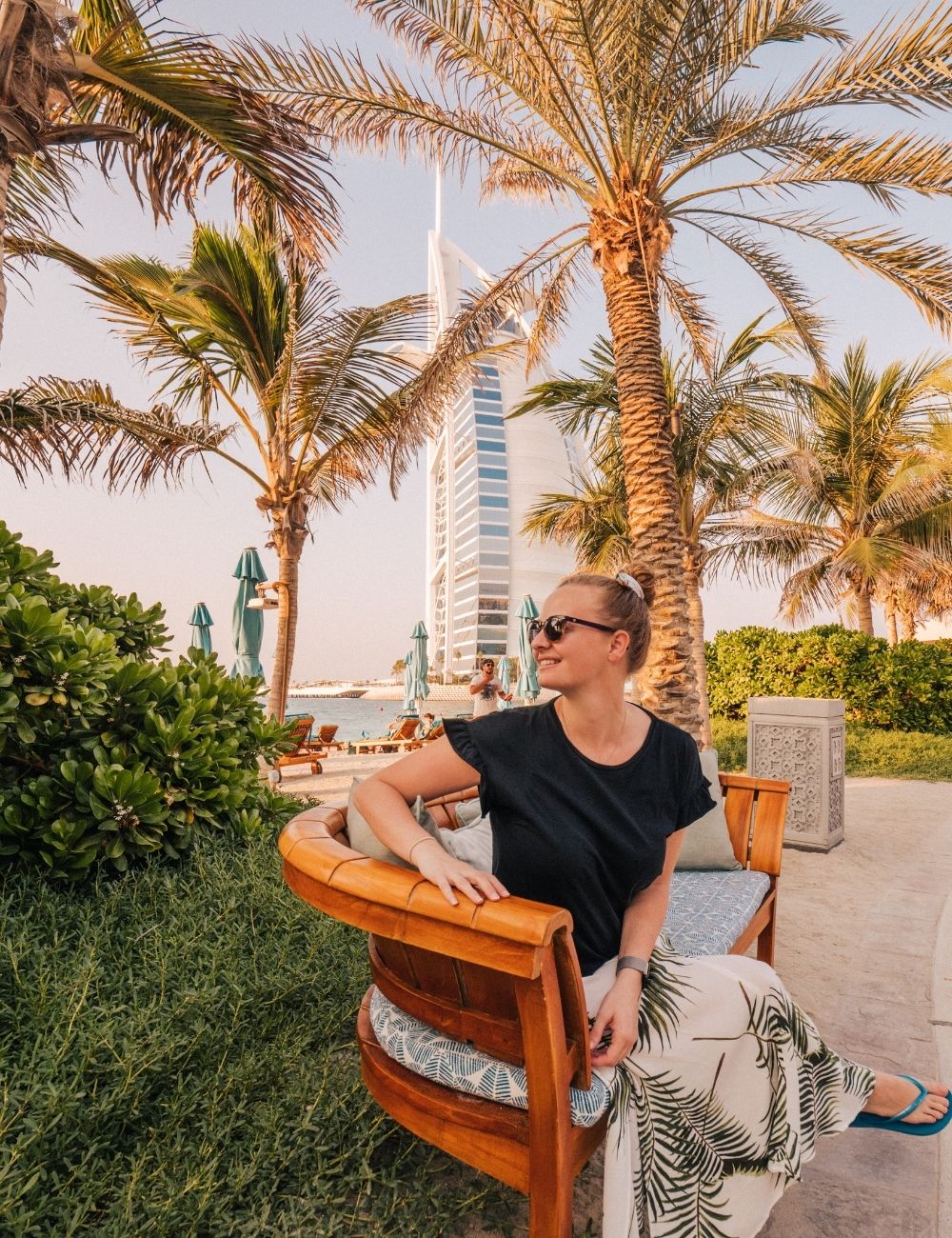 girl sitting in front of burj al arab in dubai