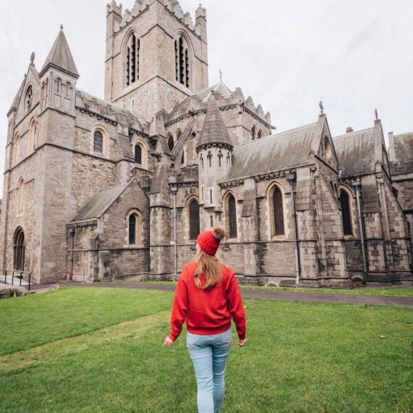 girl walking in front of dublin church
