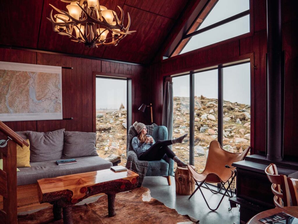 girl sitting on chair in high country cabin twizel