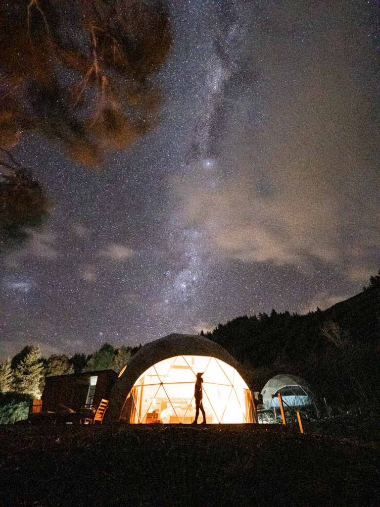 alexx standing in front of the dome at night underneath the milky way