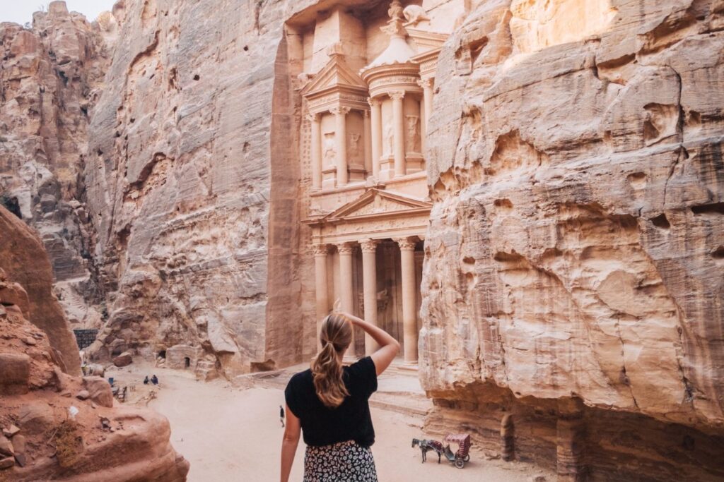 alexx standing in front of petra ruins in jordan