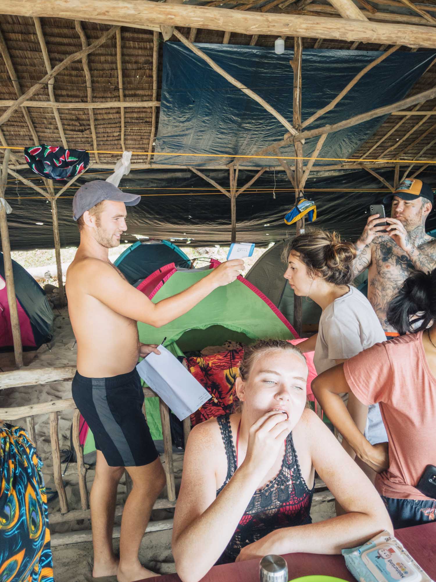 Our guide Tommy checking tourmates' temperatures at the Philippines beach camp