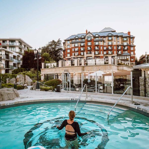 alexx swimming in mineral pool in front of oak bay beach hotel