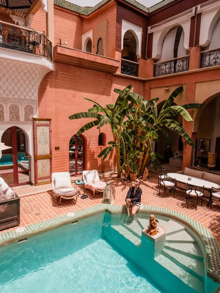 Overlooking the inviting pool and lush greenery of Riad Indian Palace, this spot is a tranquil retreat ideal for solo female travellers in Marrakech