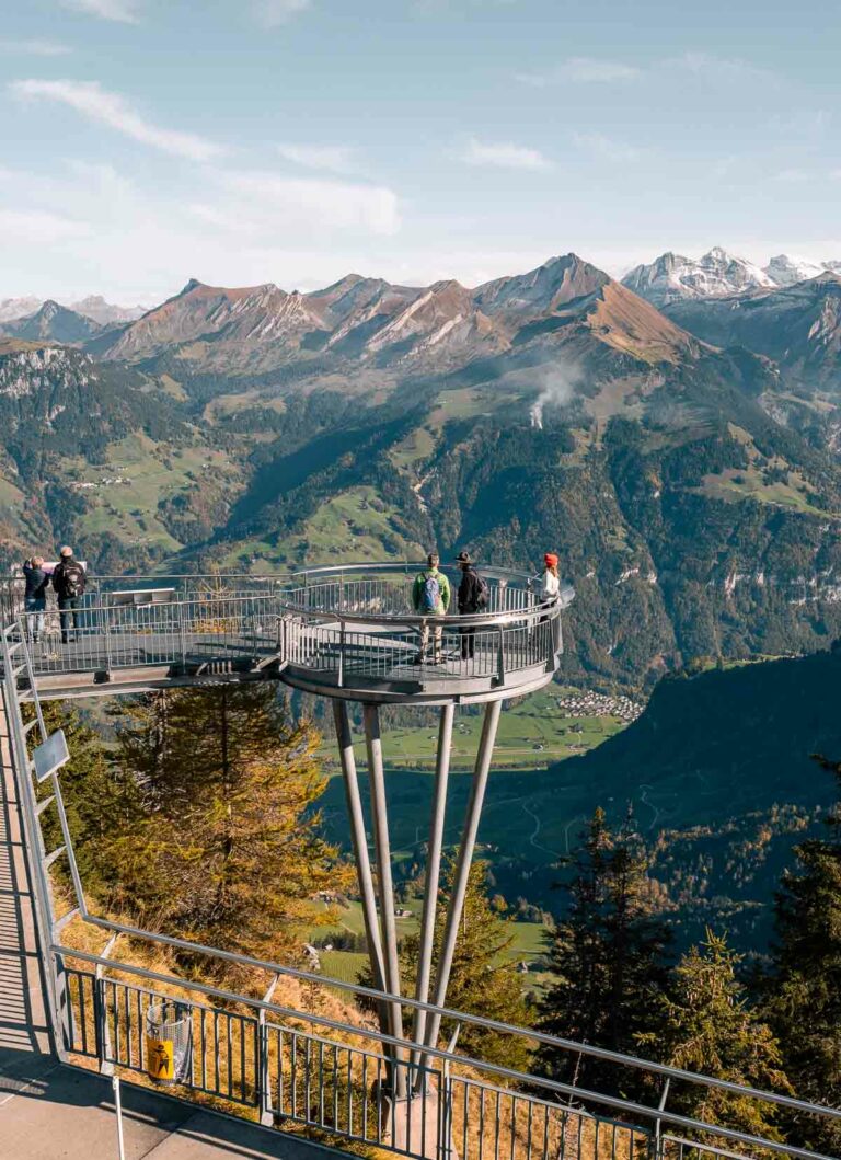 Visitors on the Stanserhorn's summit viewing platform overlook a stunning panorama of the Swiss Alps, an immersive experience in the heart of nature