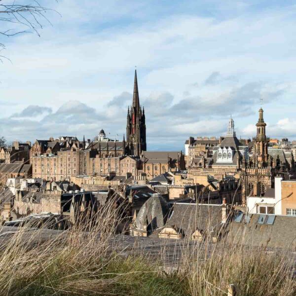 Breathtaking view from the rooftop terrace of the National Museum of Scotland, overlooking the historic Edinburgh Castle and the city's skyline, a must-visit spot for anyone travelling alone in Edinburgh