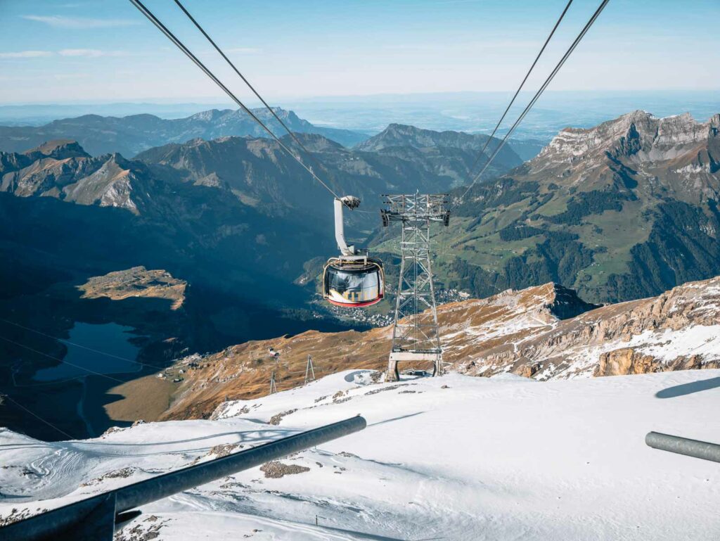 The Rotair, Titlis' rotating cable car, offers panoramic views as it ascends towards the snowy summit, a unique alpine experience
