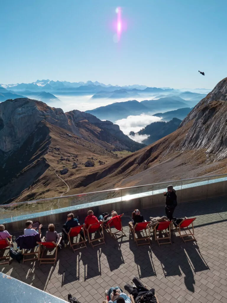Visitors enjoying mountain views from an outdoor terrace at Mount Pilatus near Lucerne