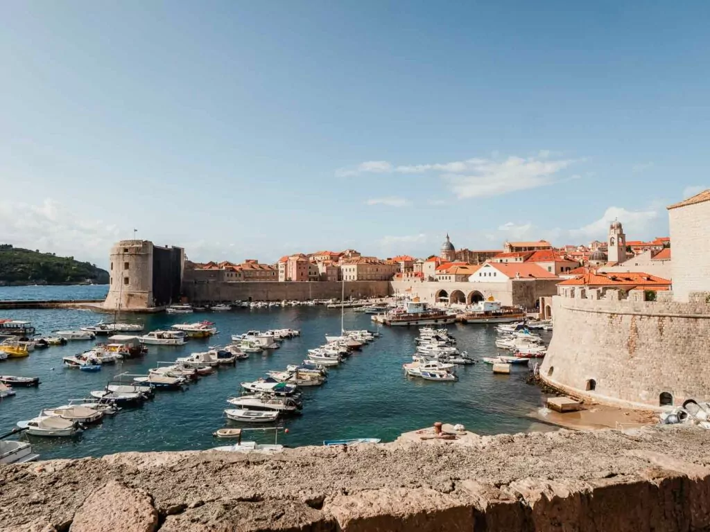 The historic old town of Dubrovnik, Croatia, with its distinctive orange rooftops, surrounded by the Adriatic Sea, inviting exploration and adventure.