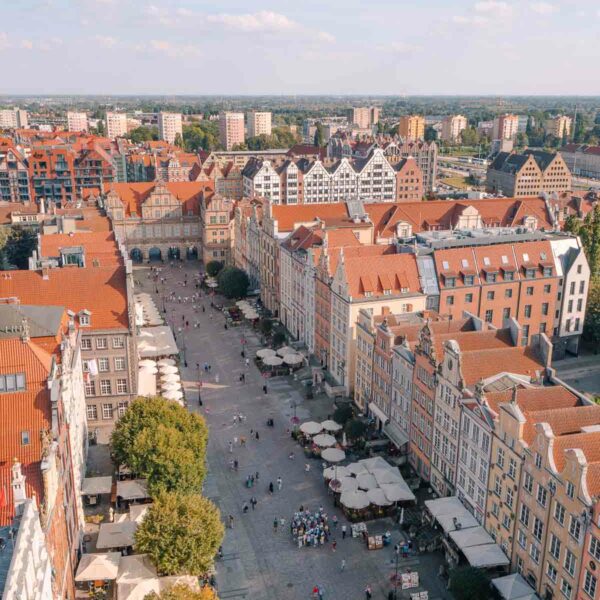 Aerial view of Gdańsk Old Town showing distinctive European architecture with rows of colourful buildings and a street bustling with people