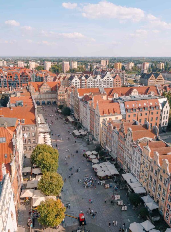 Aerial view of Gdańsk Old Town showing distinctive European architecture with rows of colourful buildings and a street bustling with people