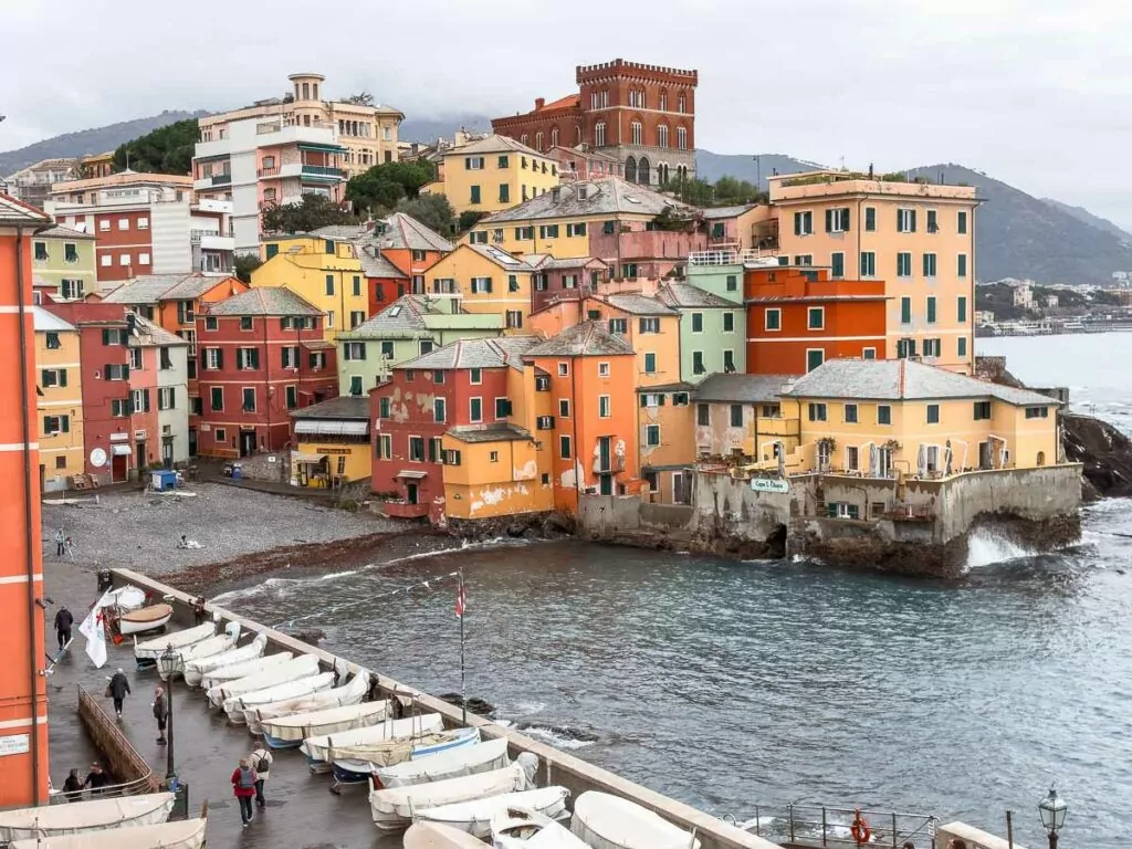 The picturesque coastal village of Boccadasse in Genoa, featuring colorful houses against a backdrop of the sea, perfect for a Northern Italy and Switzerland itinerary
