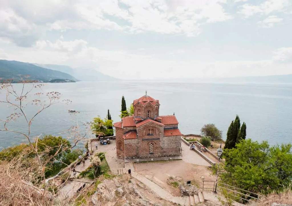 The serene Church of St. John at Kaneo, perched on a clifftop overlooking the tranquil Lake Ohrid, Macedonia, a must-visit for a two weeks Balkans itinerary