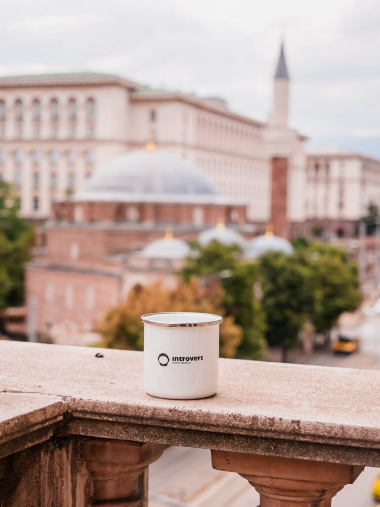 Coffee cup with the backdrop of Sofia's skyline, symbolising a morning break in Sofia