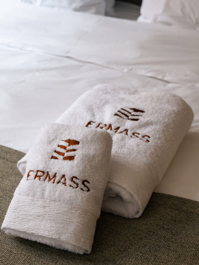 Two neatly folded towels embroidered with 