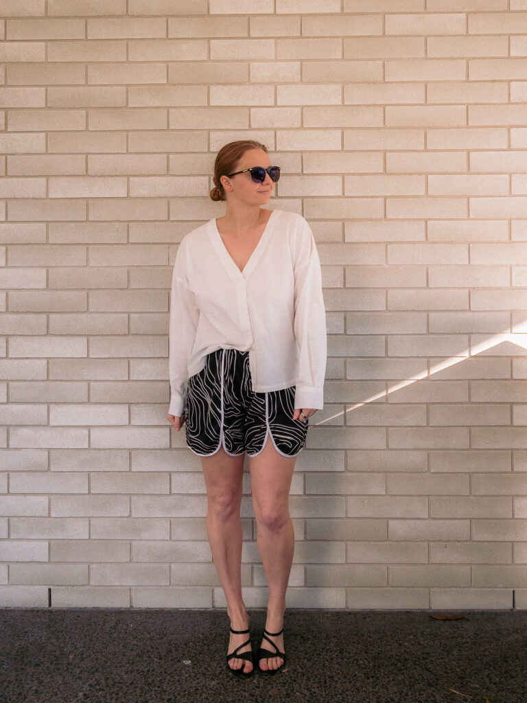 White V-neck linen top from Heritage tailor with black and white piped shorts from Linh tailor, Hoi An
