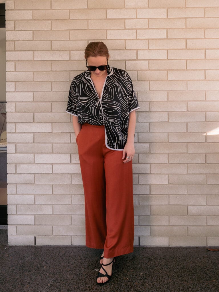 Black and white piped short sleeve top from Linh tailor in Hoi An, worn with rust trousers