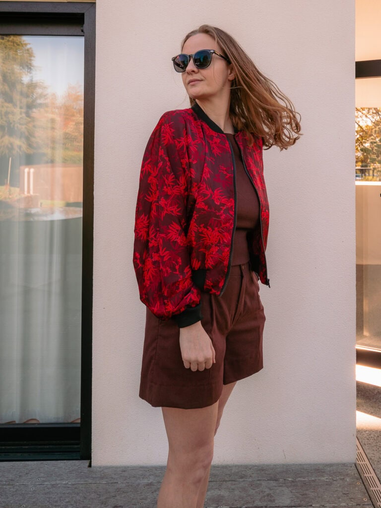 Red and black floral bomber jacket from Blue Lantern tailor over a chocolate brown linen set from Pink Lotus, Hoi An