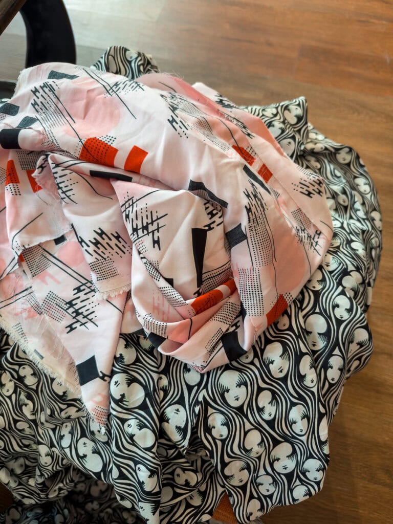 Draped fabric in a coral and black abstract print at a Hoi An tailor
