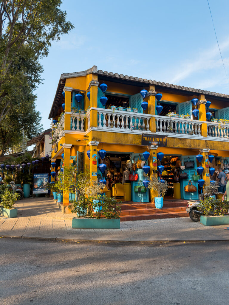 Yellow two-storey tailor shopfront on a Hoi An street