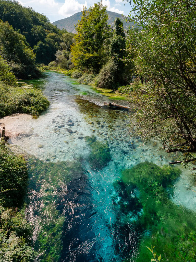 Crystal clear waters reveal countless shades of blue and green in Blue Eye Spring's depths, perfect for solo travellers in Albania seeking natural wonders.